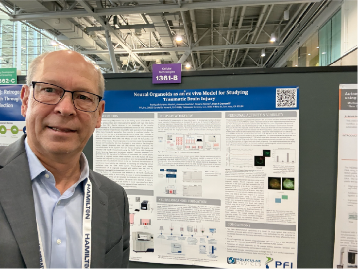 Dr. Evan Cromwell standing in front of his SLAS2026 Poster